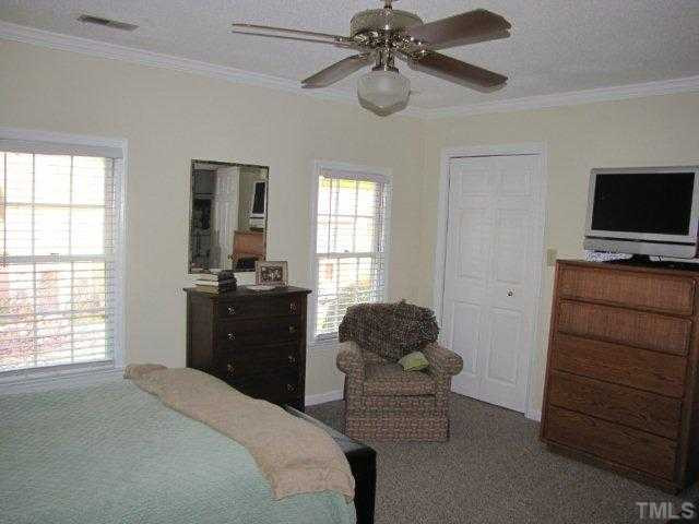 5635 Bridgetowne Way Raleigh, NC 27609 - Photo 13 of 18 a bedroom with a bed and a television
