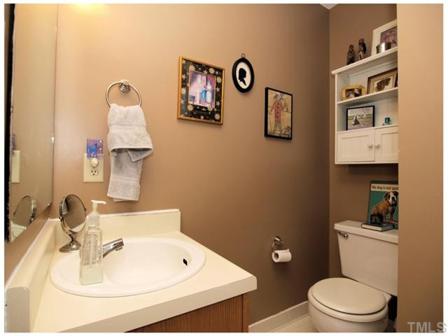 5635 Bridgetowne Way Raleigh, NC 27609 - Photo 14 of 18 a bathroom with a toilet sink and mirror