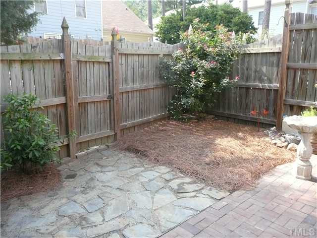 5635 Bridgetowne Way Raleigh, NC 27609 - Photo 16 of 18 a view of backyard with wooden fence and large trees