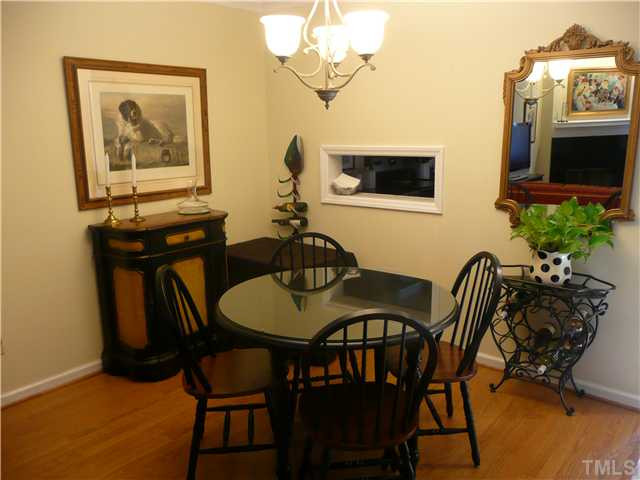 5635 Bridgetowne Way Raleigh, NC 27609 - Photo 4 of 18 a view of a dining room with furniture and wooden floor
