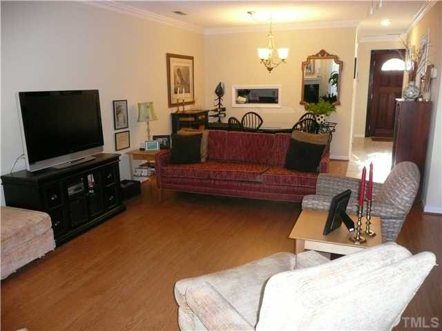 5635 Bridgetowne Way Raleigh, NC 27609 - Photo 6 of 18 a living room with furniture and a flat screen tv