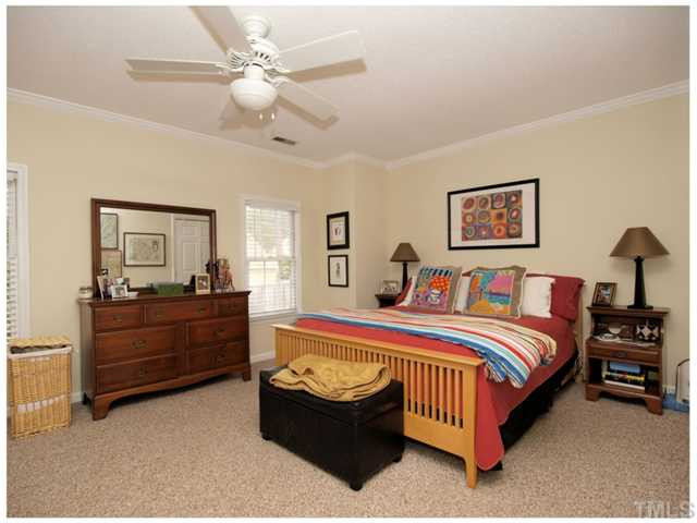 5635 Bridgetowne Way Raleigh, NC 27609 - Photo 9 of 18 a bed room with a bed and a chandelier
