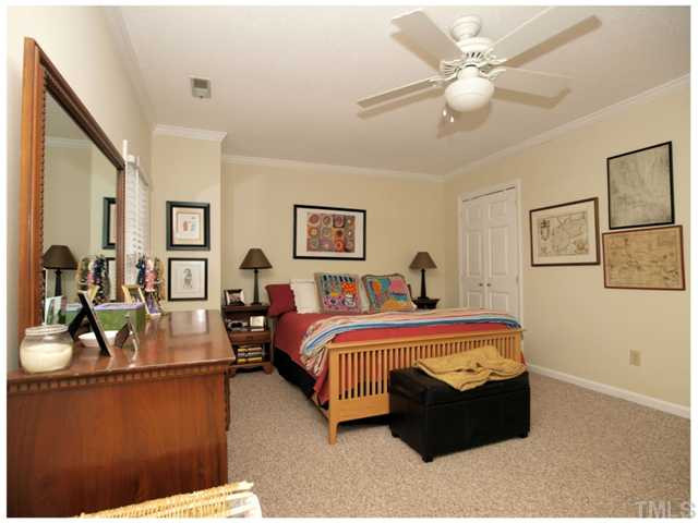 5635 Bridgetowne Way Raleigh, NC 27609 - Photo 10 of 18 a bed room with furniture and a chandelier