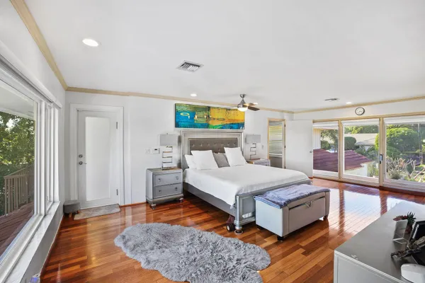 a bedroom with a bed and large window with outer view