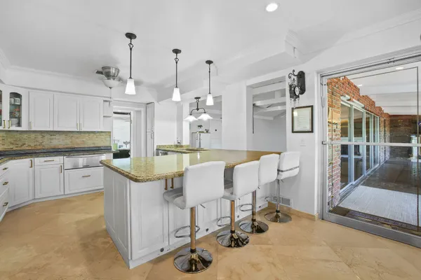 a view of kitchen and dining area with chandelier