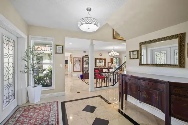 a view of a hallway with furniture and windows