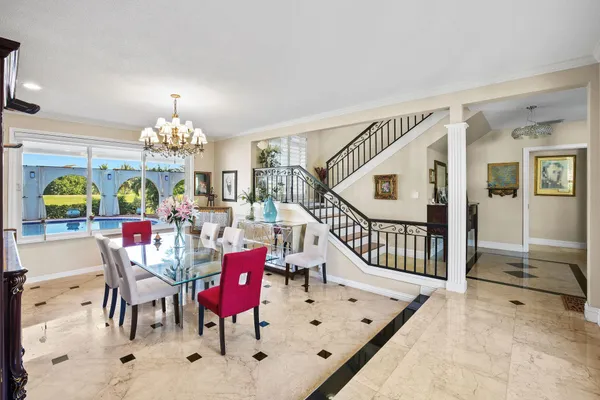 a view of a dining room with furniture and chandelier