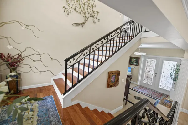 a view of entryway and hall with wooden floor
