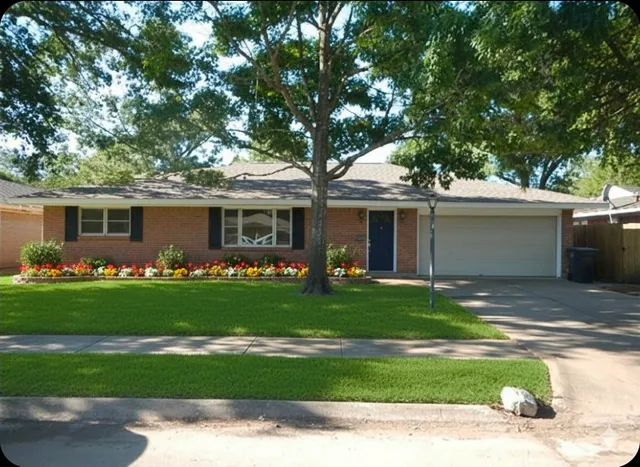 a front view of a house with a garden