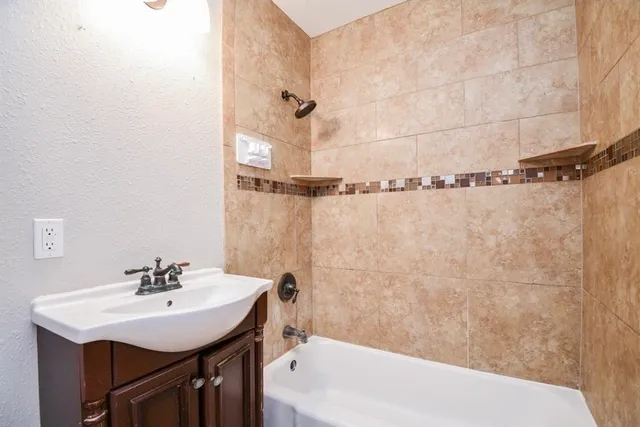 a bathroom with a sink a mirror and a bathtub