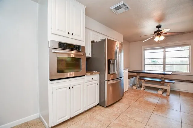 a kitchen with stainless steel appliances a stove microwave and cabinets