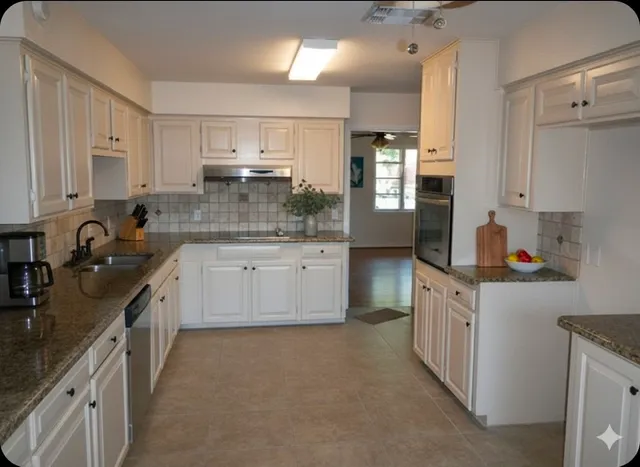 a kitchen with granite countertop a sink stove and cabinets