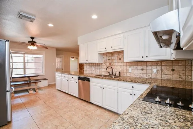 a kitchen with a sink stove and cabinets