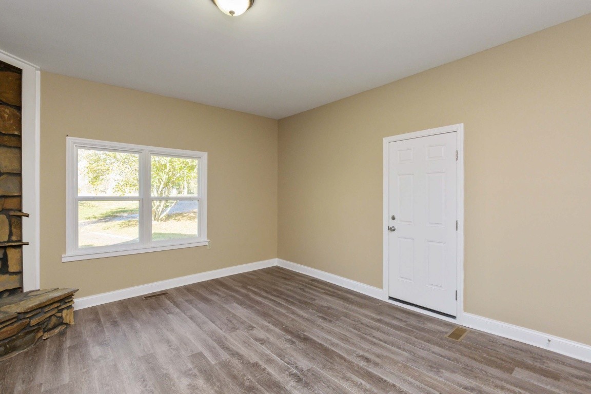 2480 Mann Road Lebanon, TN 37087 - Photo 13 of 35 an empty room with wooden floor and windows