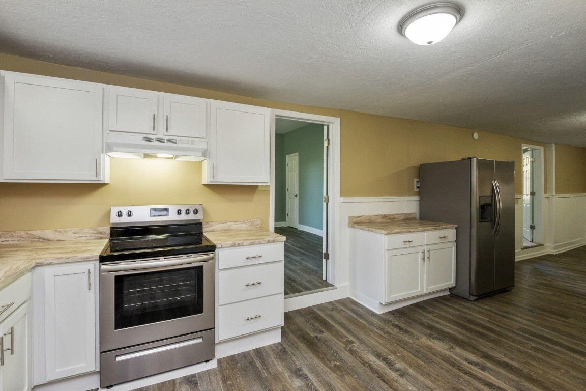 2480 Mann Road Lebanon, TN 37087 - Photo 14 of 35 a kitchen with granite countertop a stove and a refrigerator