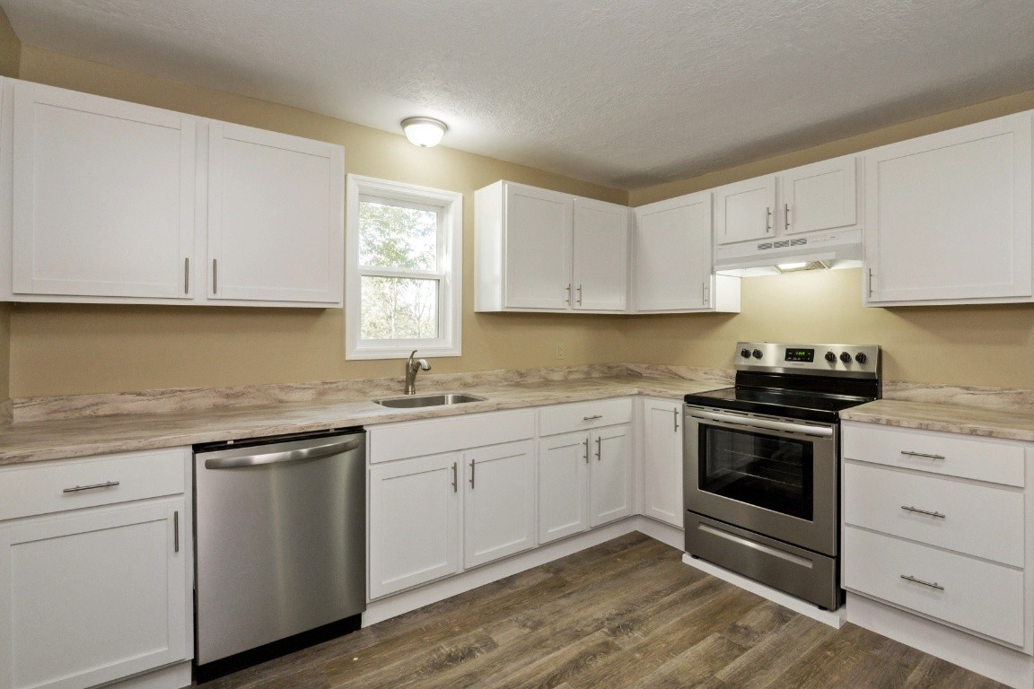 2480 Mann Road Lebanon, TN 37087 - Photo 15 of 35 a kitchen with granite countertop white cabinets and white appliances