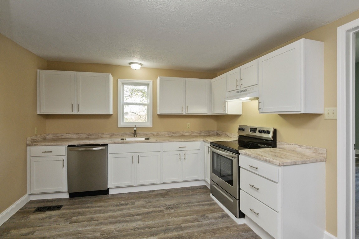 2480 Mann Road Lebanon, TN 37087 - Photo 16 of 35 a kitchen with a stove top oven sink and cabinets