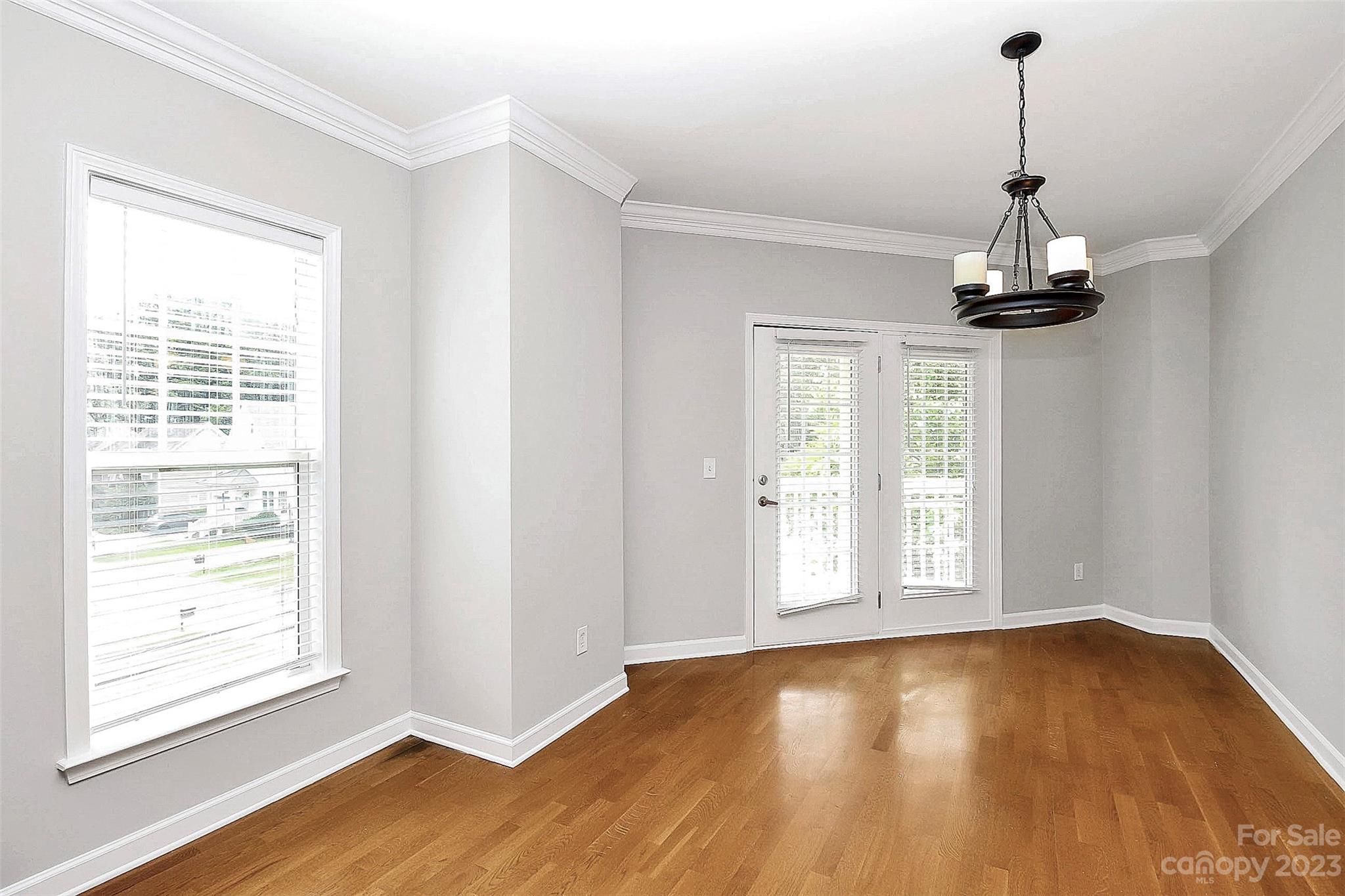 4162 Walker Road Charlotte, NC 28211 - Photo 9 of 25 a view of an empty room with wooden floor and a window