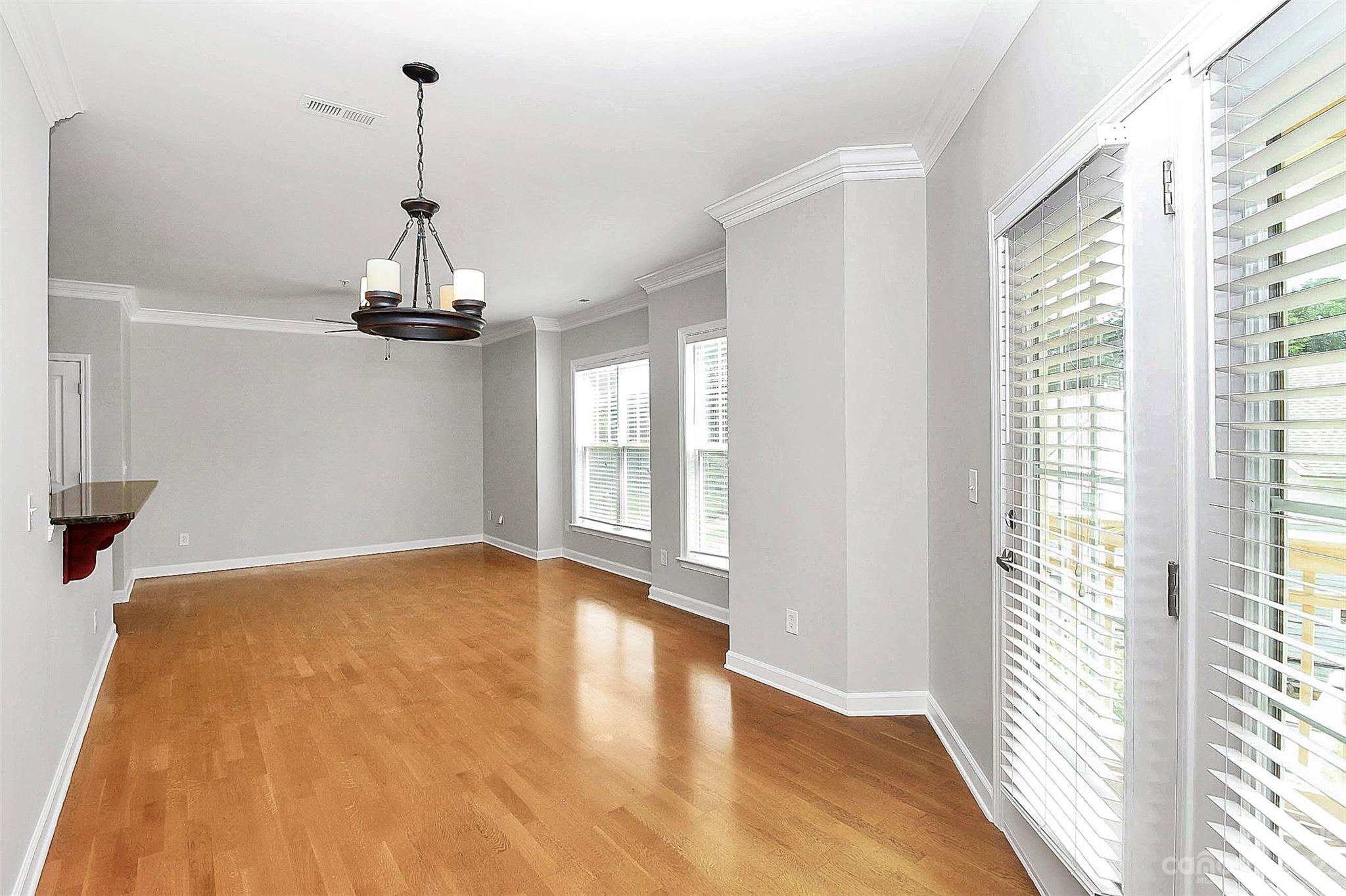 4162 Walker Road Charlotte, NC 28211 - Photo 10 of 25 a view of empty room with wooden floor and fan