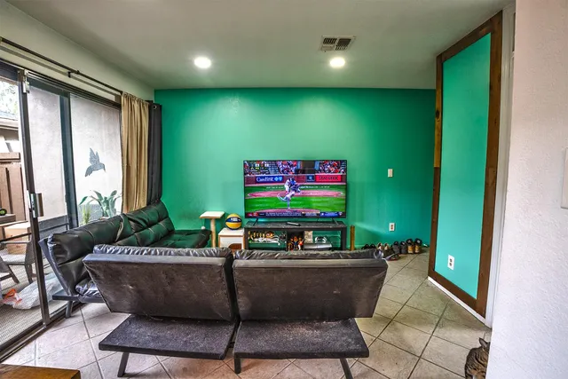 a room with furniture projector and screen