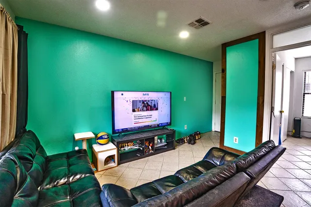 a living room with furniture pool table and a large window