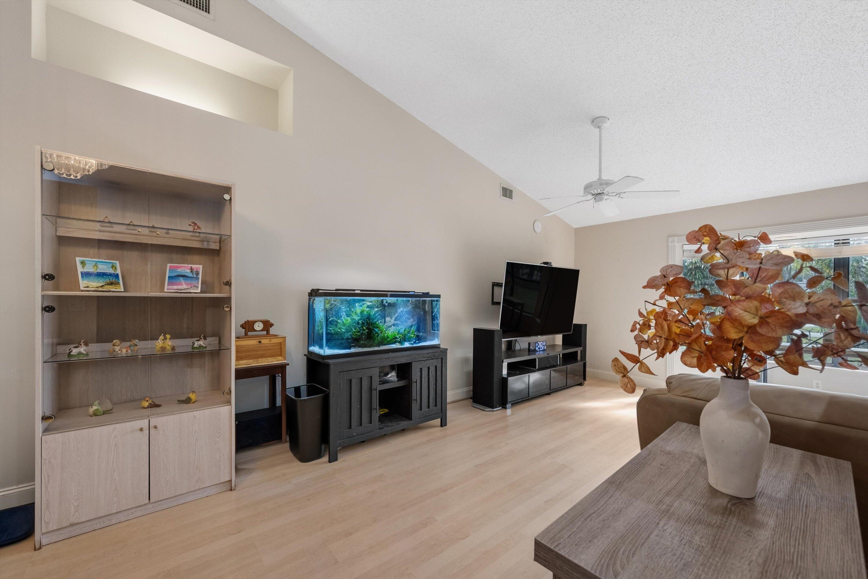 7169 154th Road North Palm Beach Gardens, FL 33418 - Photo 11 of 62 a living room with furniture and a flat screen tv