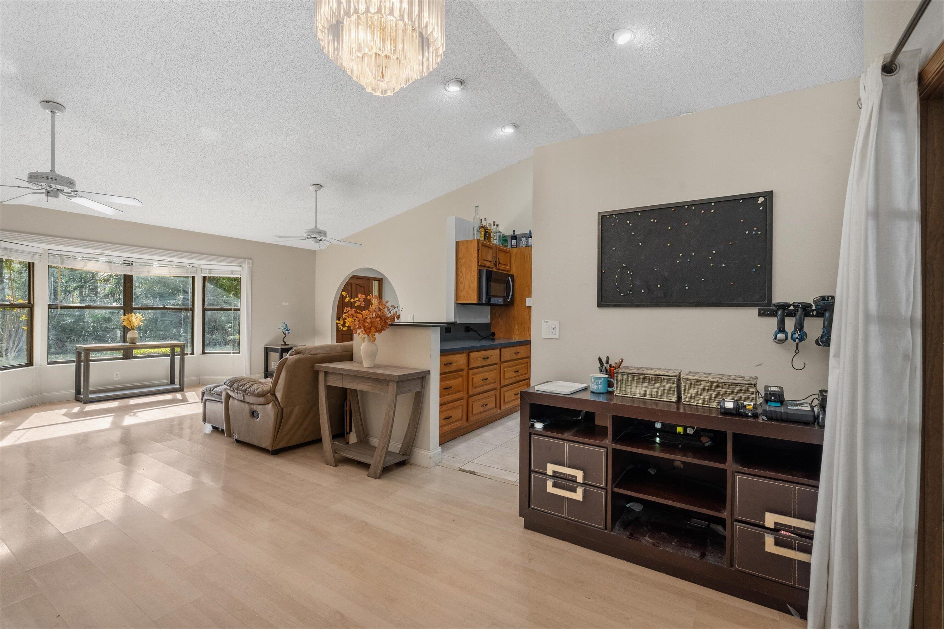 7169 154th Road North Palm Beach Gardens, FL 33418 - Photo 12 of 62 a room with furniture and flat screen tv