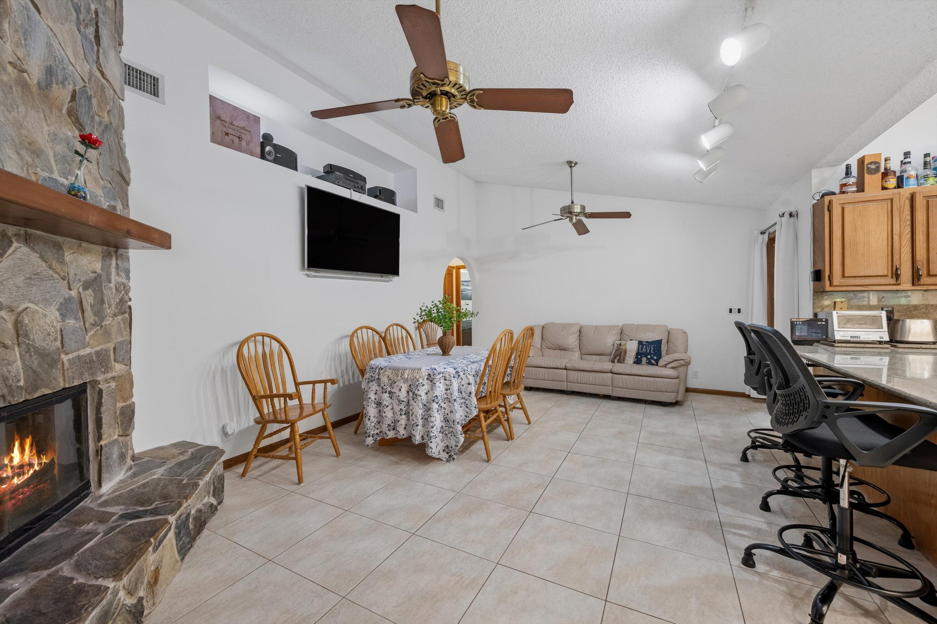 7169 154th Road North Palm Beach Gardens, FL 33418 - Photo 17 of 62 a living room with furniture a flat screen tv and kitchen view