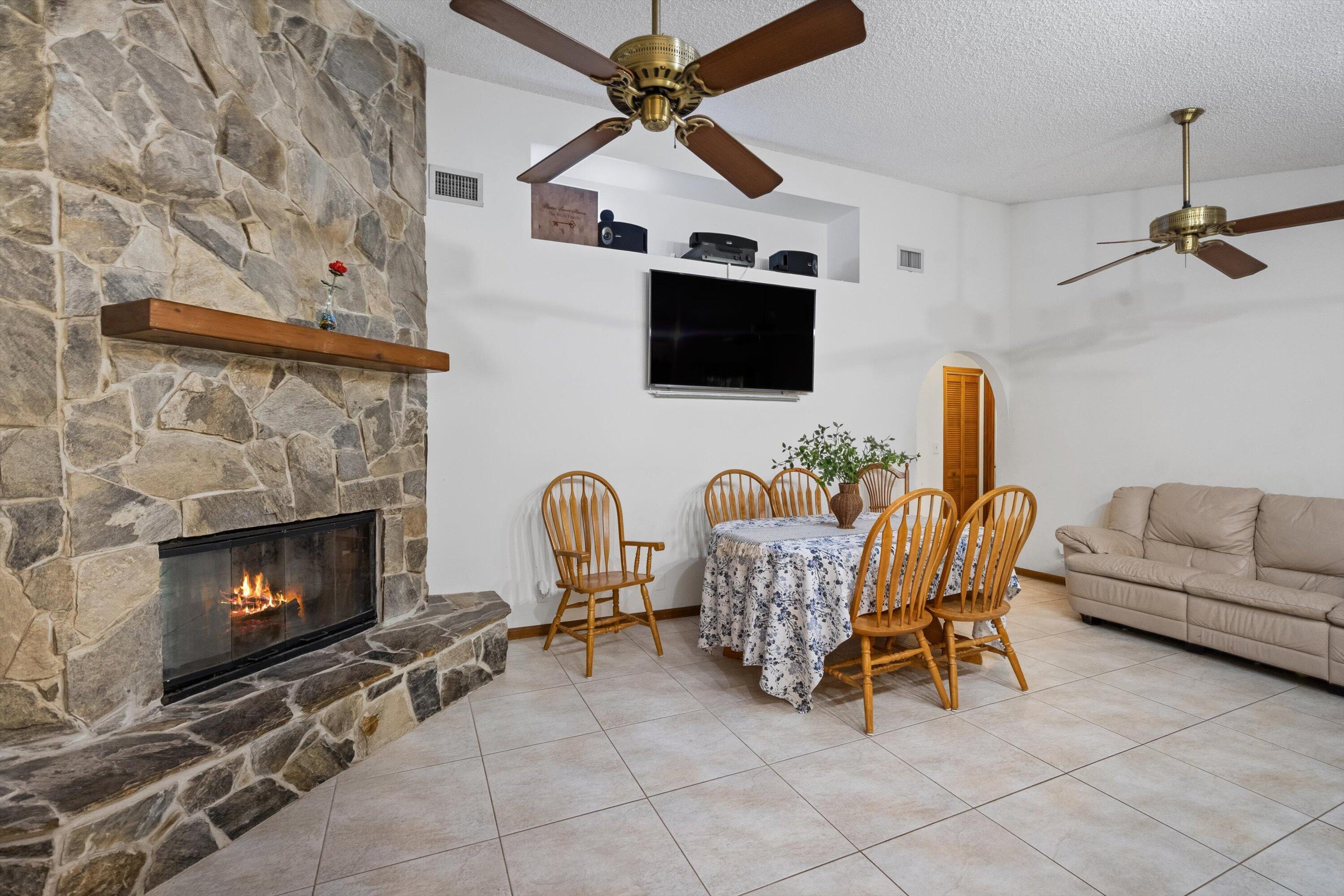 7169 154th Road North Palm Beach Gardens, FL 33418 - Photo 18 of 62 a living room with furniture a flat screen tv and a fireplace