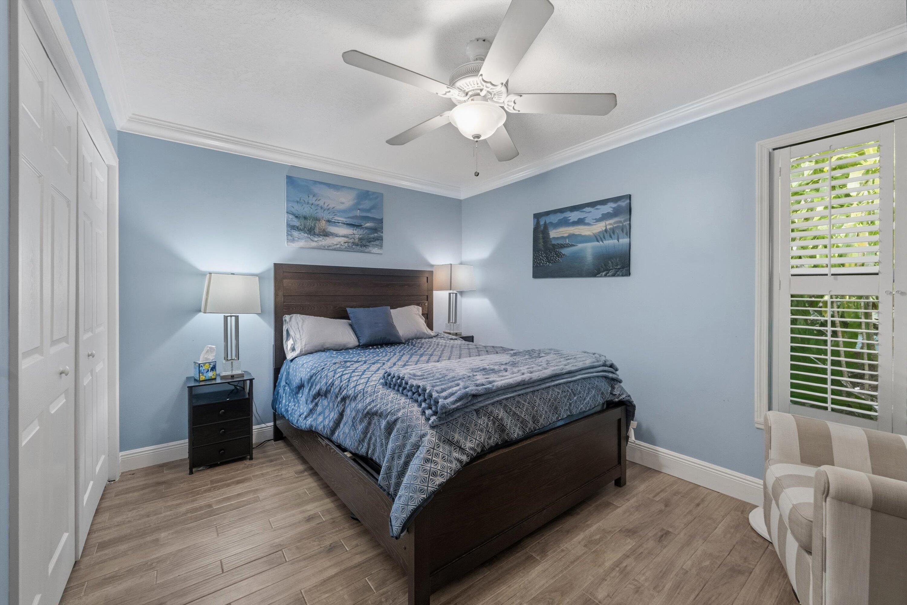 7169 154th Road North Palm Beach Gardens, FL 33418 - Photo 24 of 62 a bedroom with a bed and a chandelier