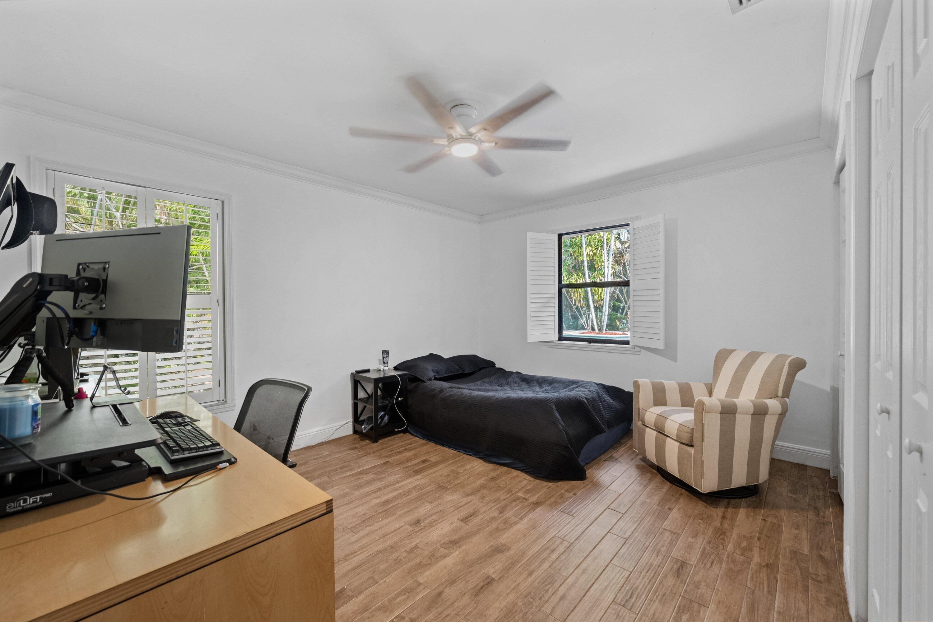 7169 154th Road North Palm Beach Gardens, FL 33418 - Photo 25 of 62 a bedroom with a bed and a window