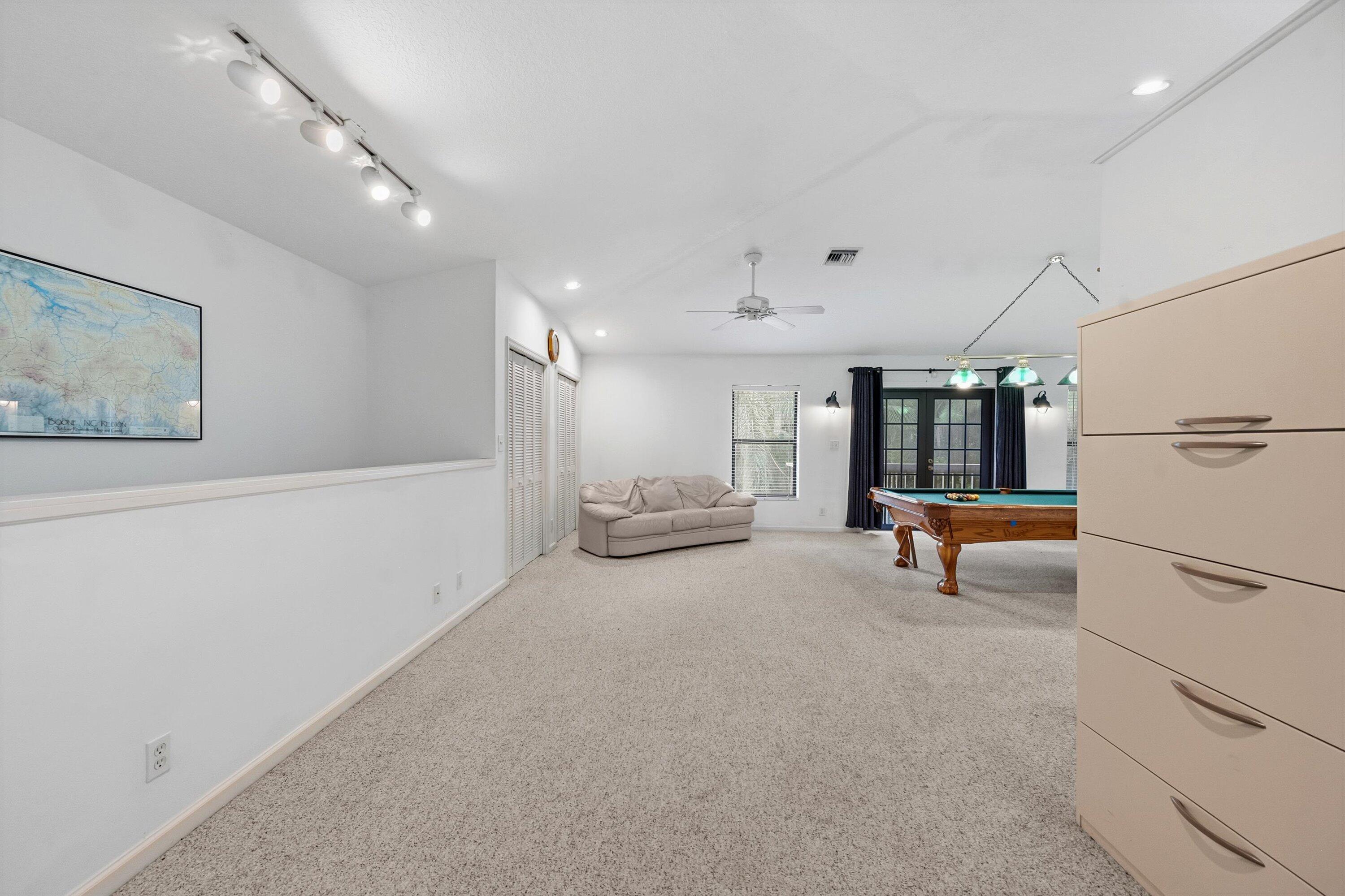 7169 154th Road North Palm Beach Gardens, FL 33418 - Photo 33 of 62 a living room with furniture and a refrigerator