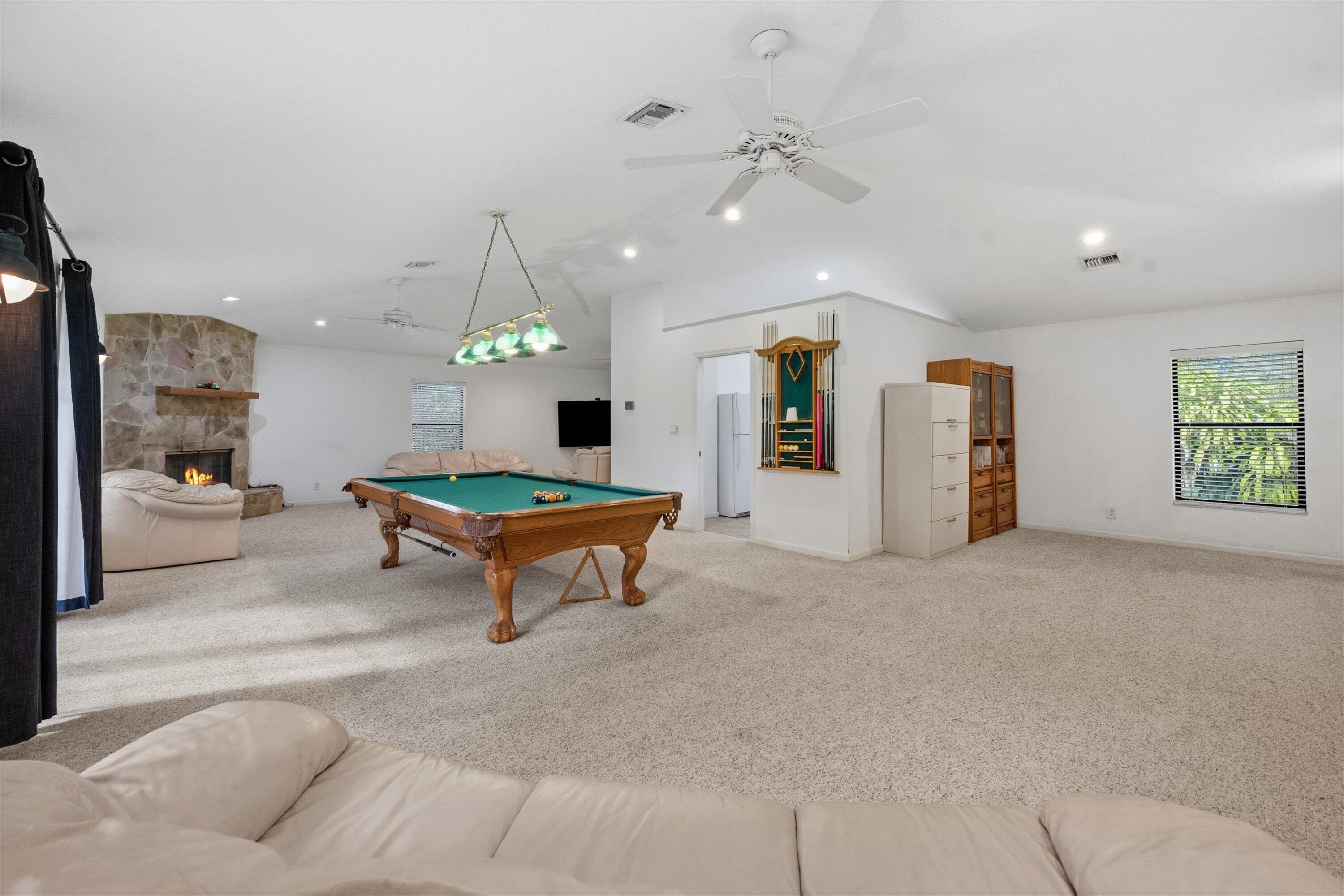 7169 154th Road North Palm Beach Gardens, FL 33418 - Photo 35 of 62 a living room with furniture and a table