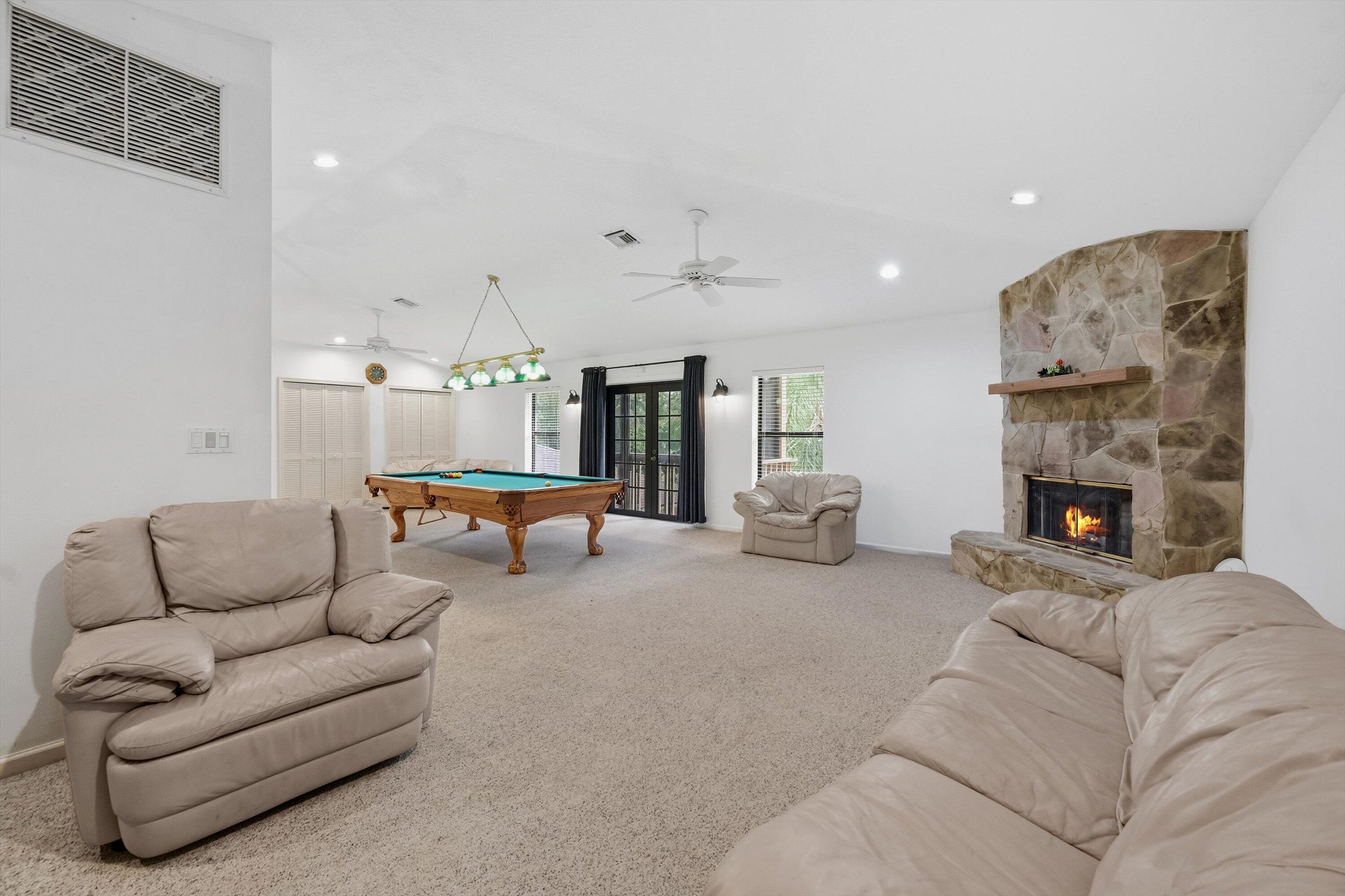 7169 154th Road North Palm Beach Gardens, FL 33418 - Photo 37 of 62 a living room with furniture and a fireplace