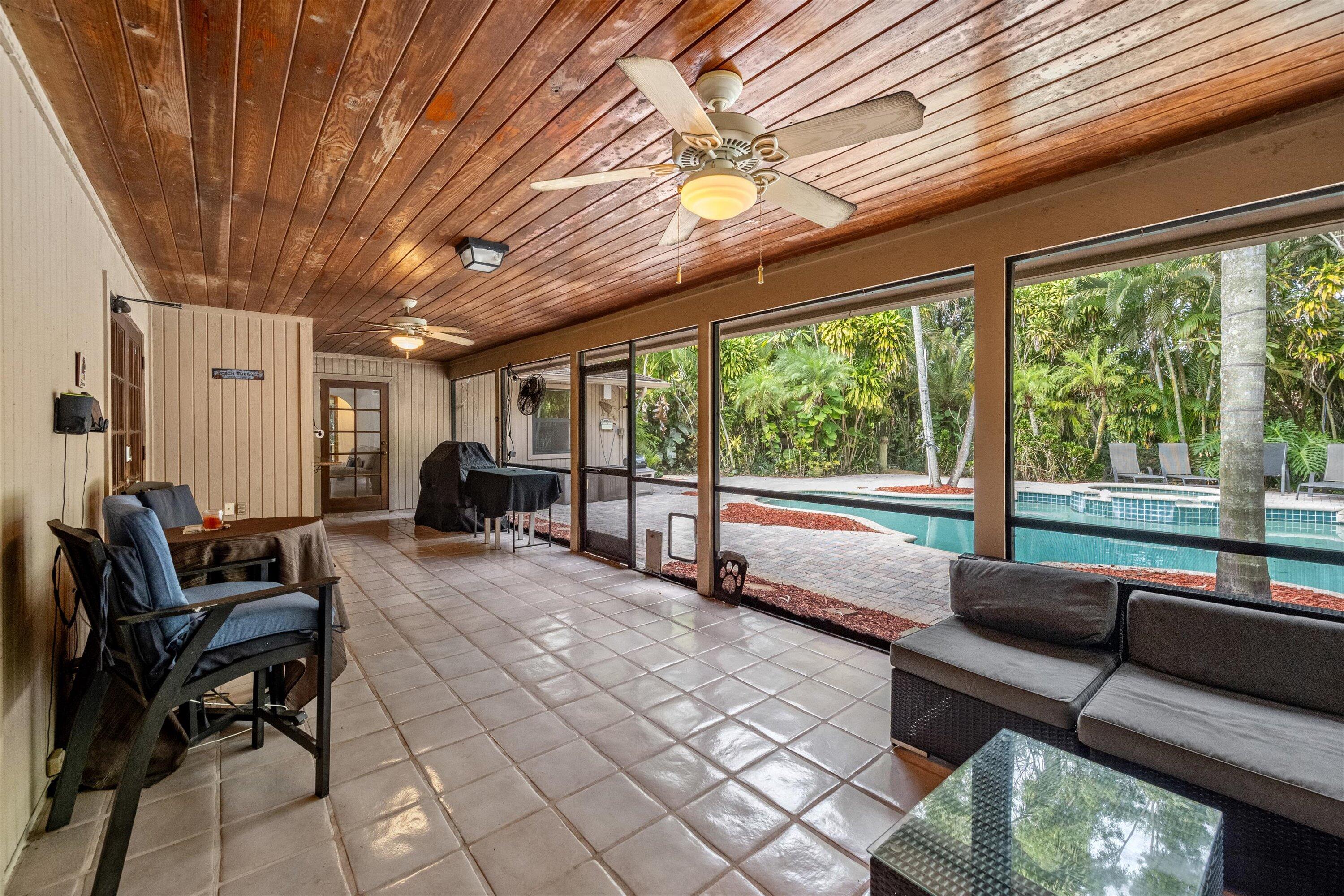 7169 154th Road North Palm Beach Gardens, FL 33418 - Photo 41 of 62 a living room with furniture and a large window