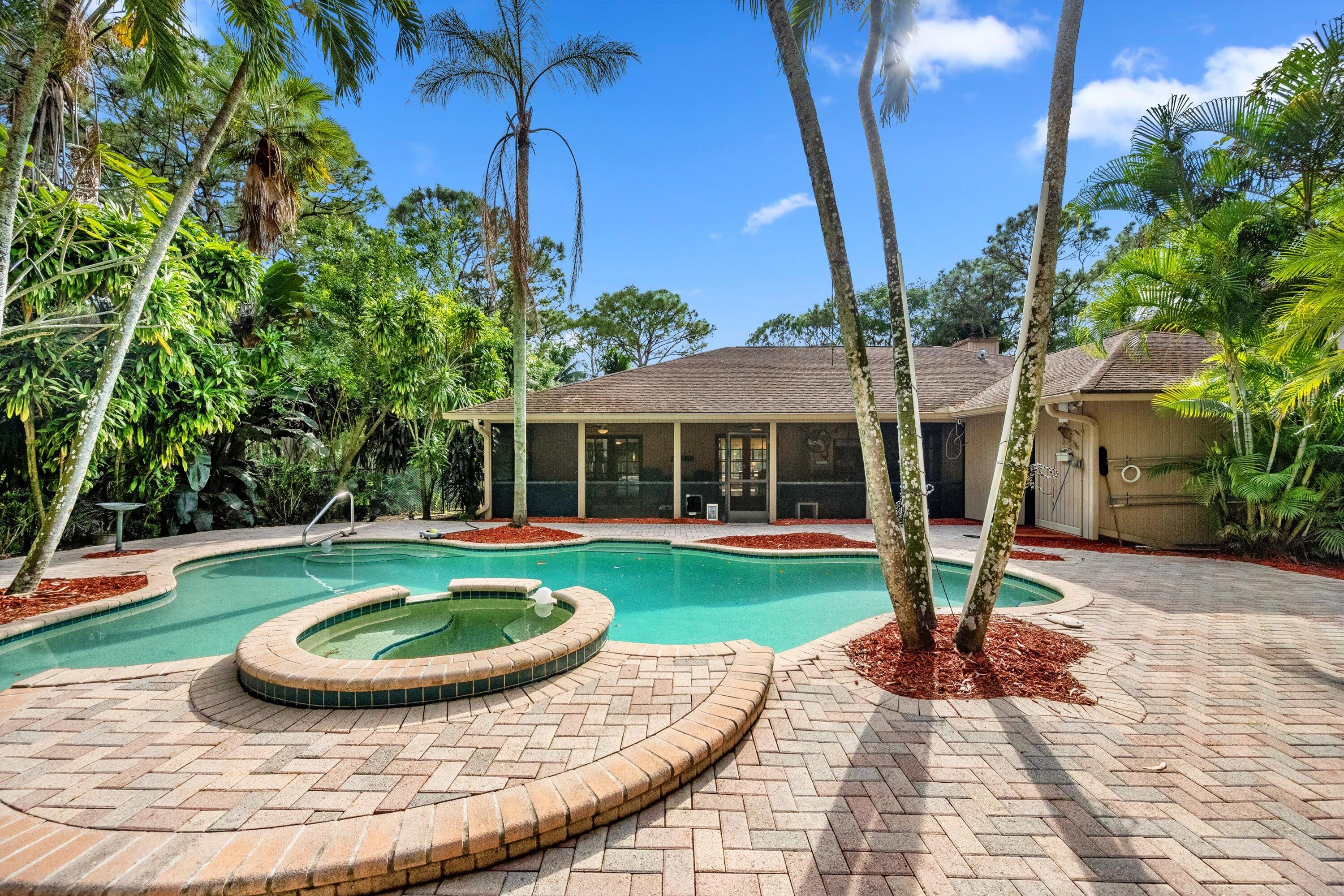 7169 154th Road North Palm Beach Gardens, FL 33418 - Photo 43 of 62 a view of a house with swimming pool and porch