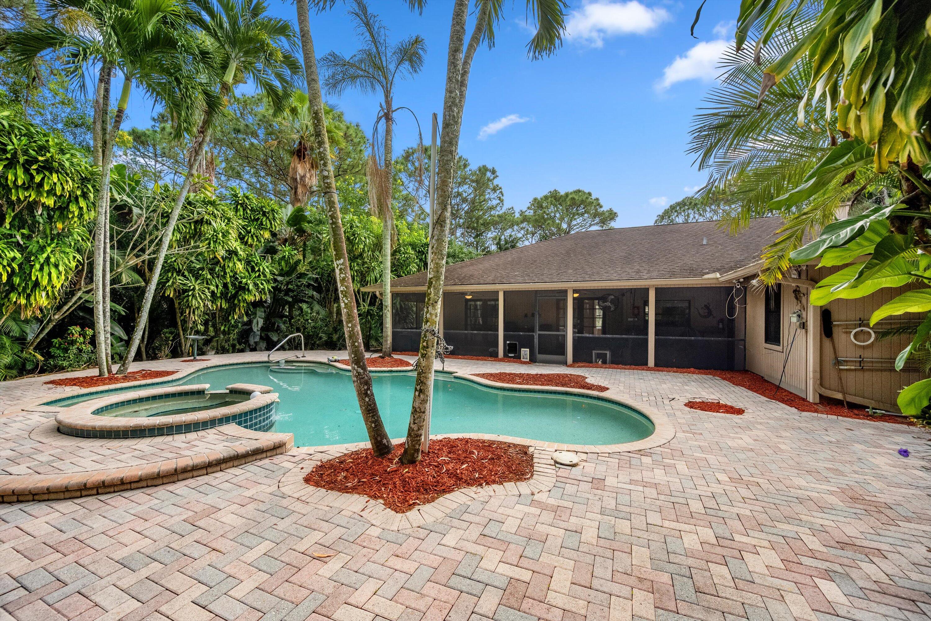 7169 154th Road North Palm Beach Gardens, FL 33418 - Photo 44 of 62 a view of a house with swimming pool and a yard