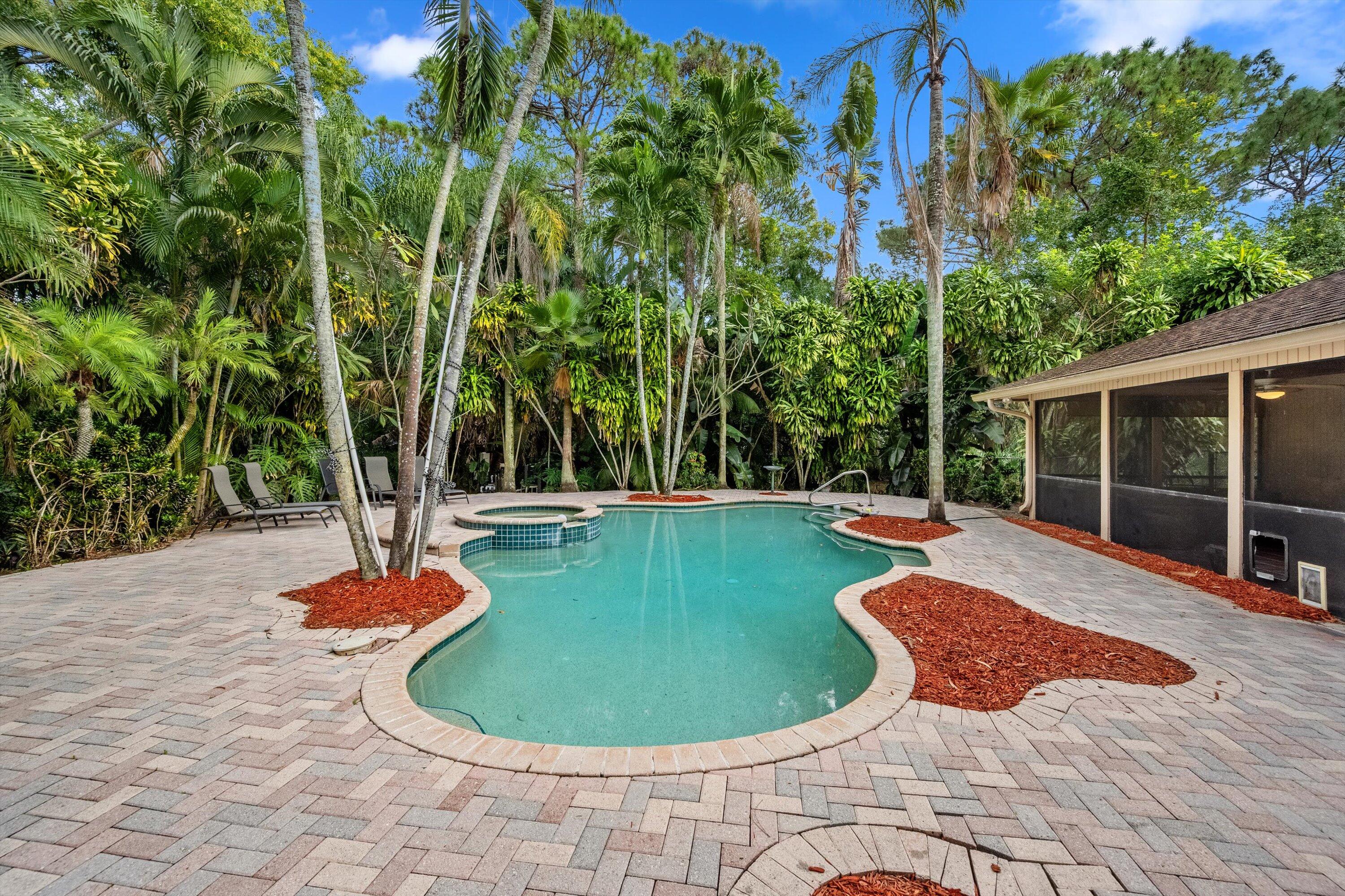 7169 154th Road North Palm Beach Gardens, FL 33418 - Photo 45 of 62 a view of a swimming pool with potted plants