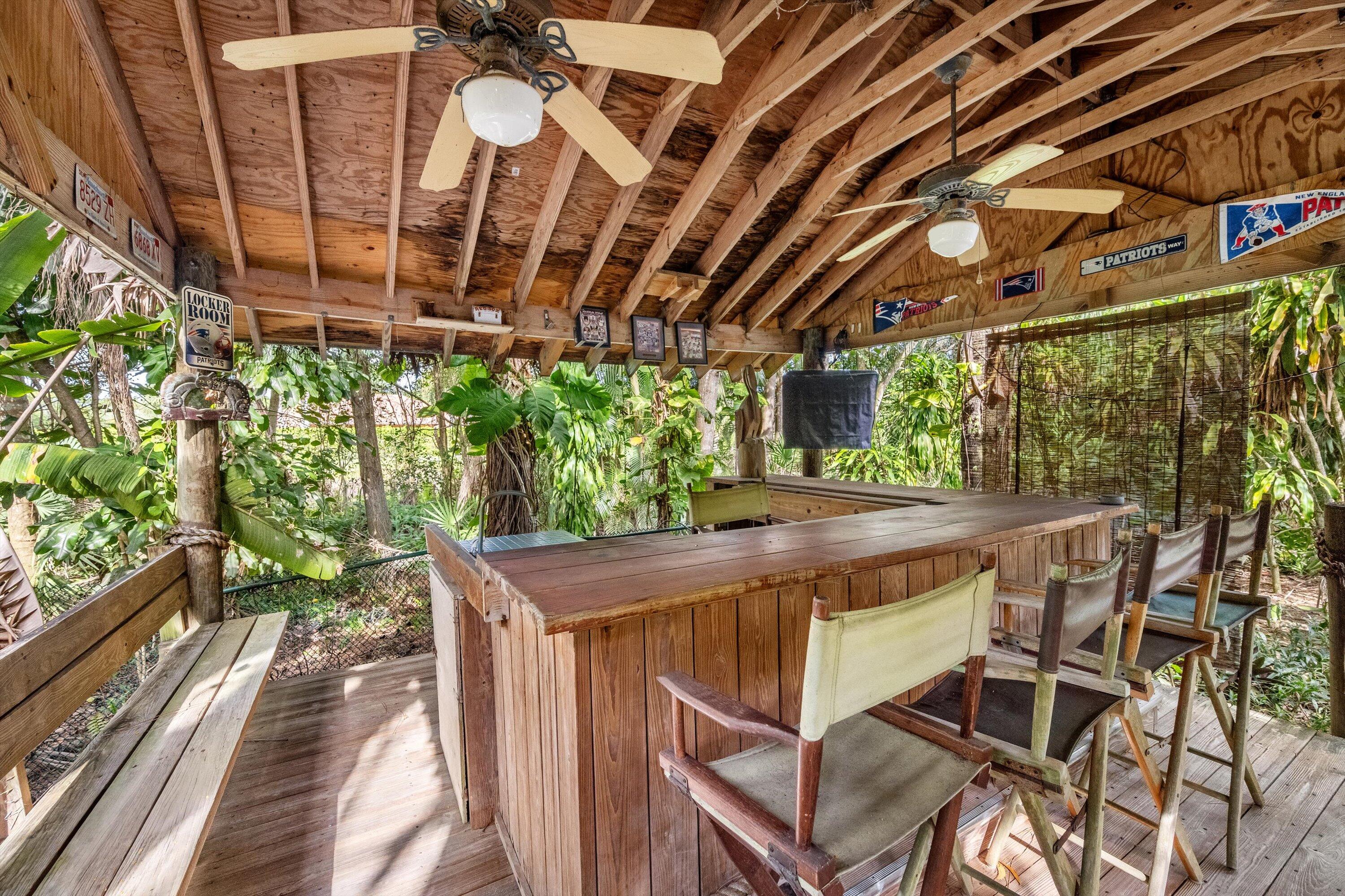 7169 154th Road North Palm Beach Gardens, FL 33418 - Photo 48 of 62 a view of a patio with table and chairs with wooden floor and fence