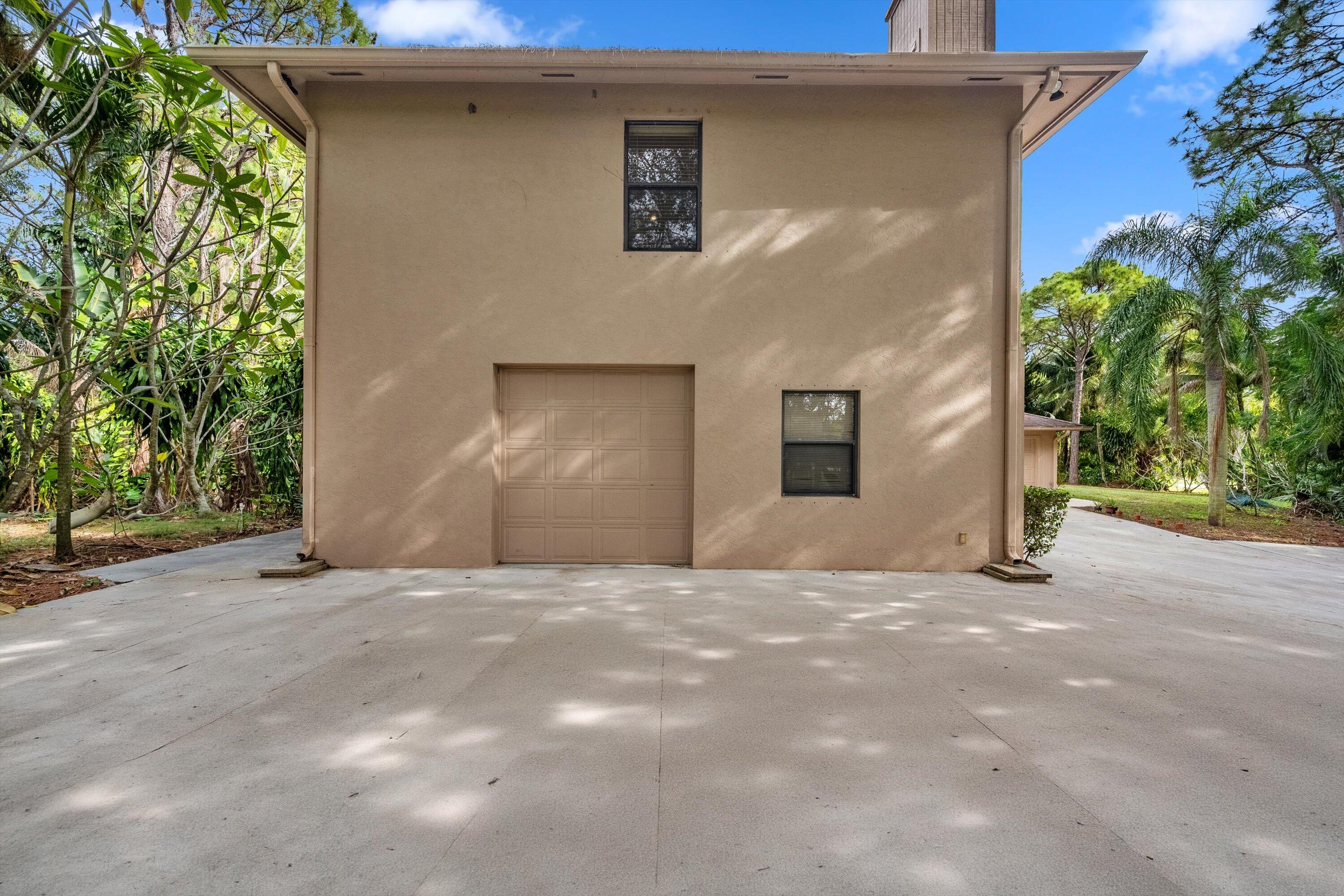 7169 154th Road North Palm Beach Gardens, FL 33418 - Photo 6 of 62 a view of a house with a garage