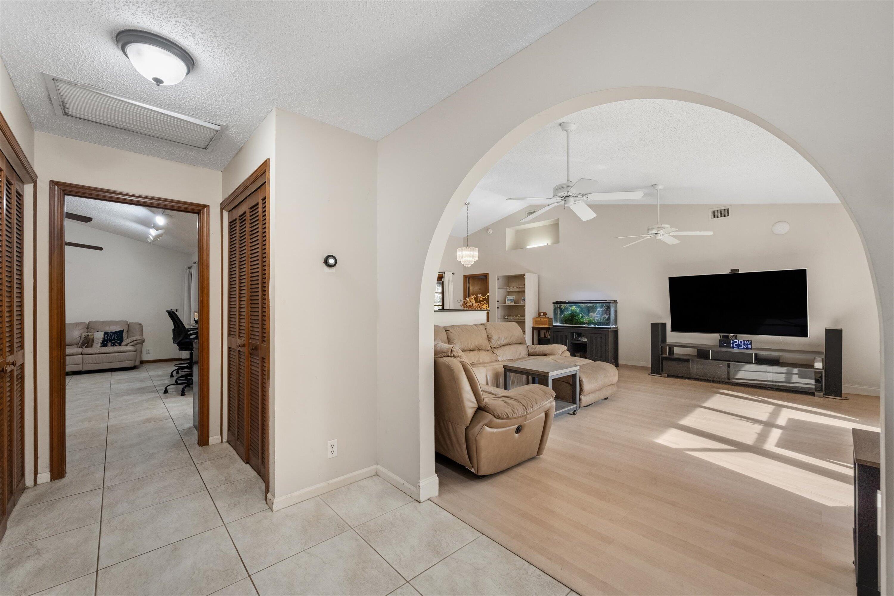 7169 154th Road North Palm Beach Gardens, FL 33418 - Photo 7 of 62 a living room with furniture and a flat screen tv