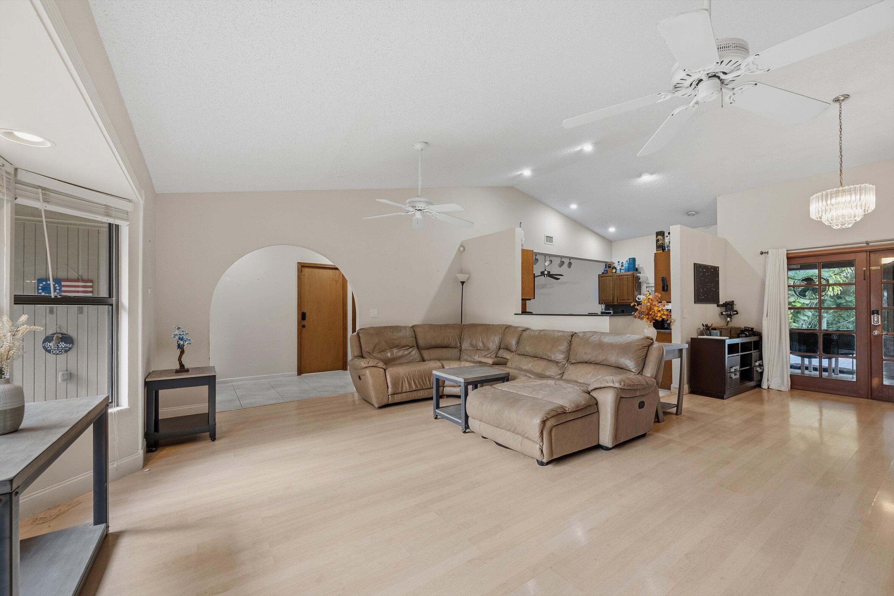 7169 154th Road North Palm Beach Gardens, FL 33418 - Photo 8 of 62 a living room with furniture and kitchen view