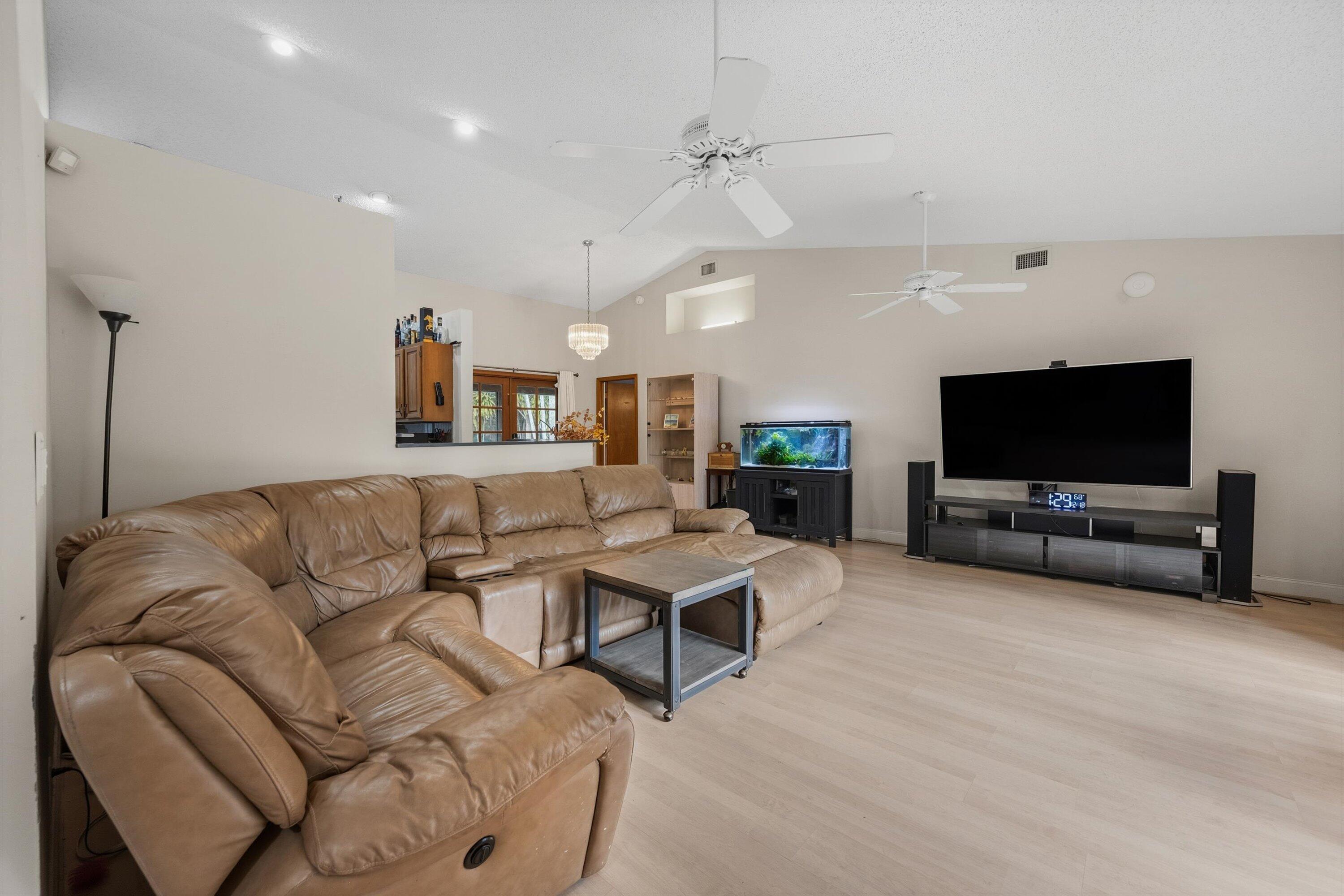 7169 154th Road North Palm Beach Gardens, FL 33418 - Photo 9 of 62 a living room with furniture and a flat screen tv
