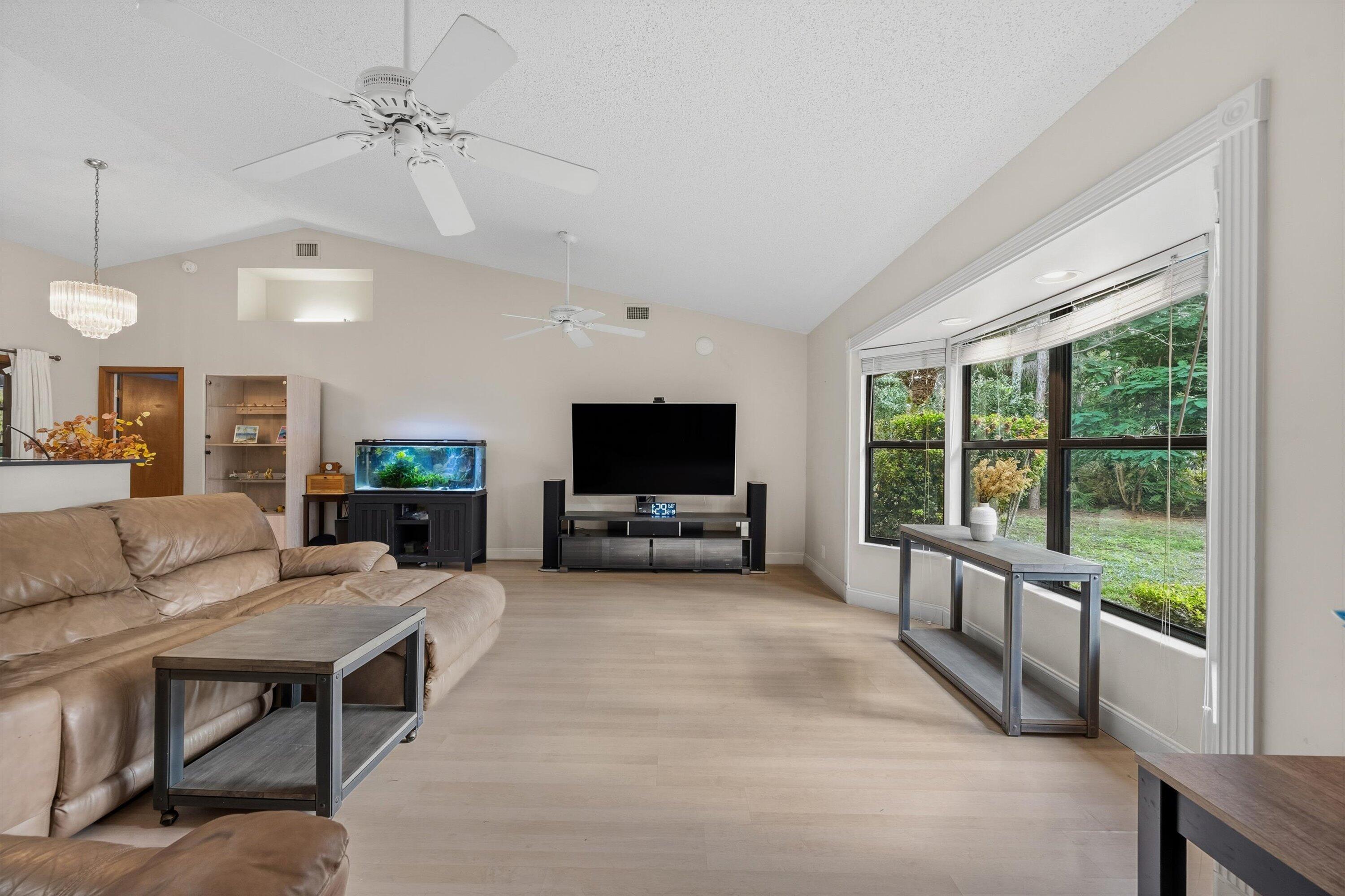 7169 154th Road North Palm Beach Gardens, FL 33418 - Photo 10 of 62 a living room with furniture and a flat screen tv