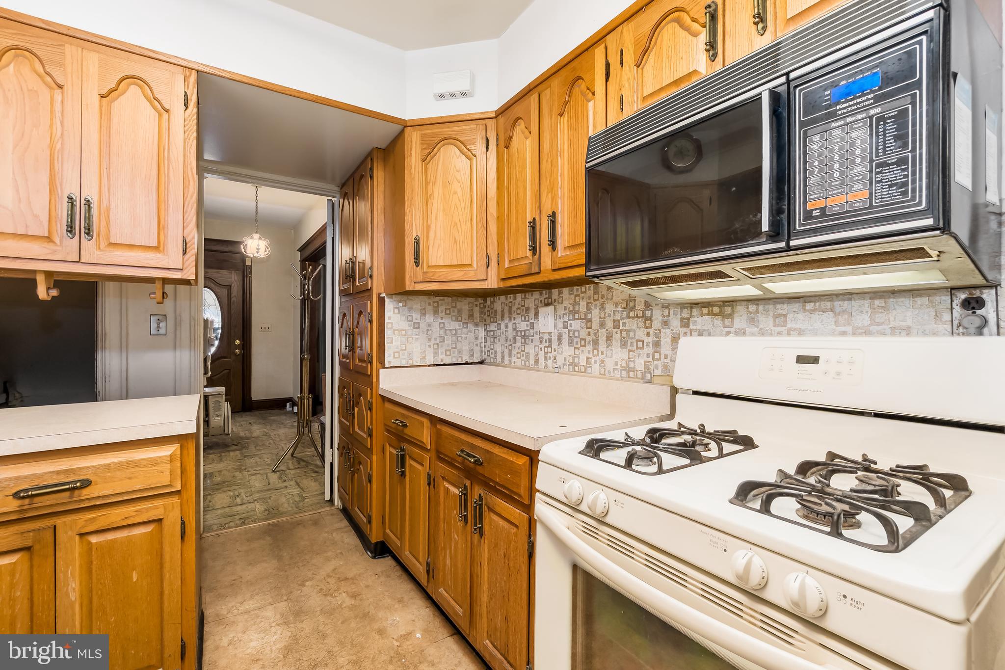 4413 7th Street Northwest Washington, DC 20011 - Photo 7 of 20 a kitchen with stainless steel appliances granite countertop a stove and a microwave