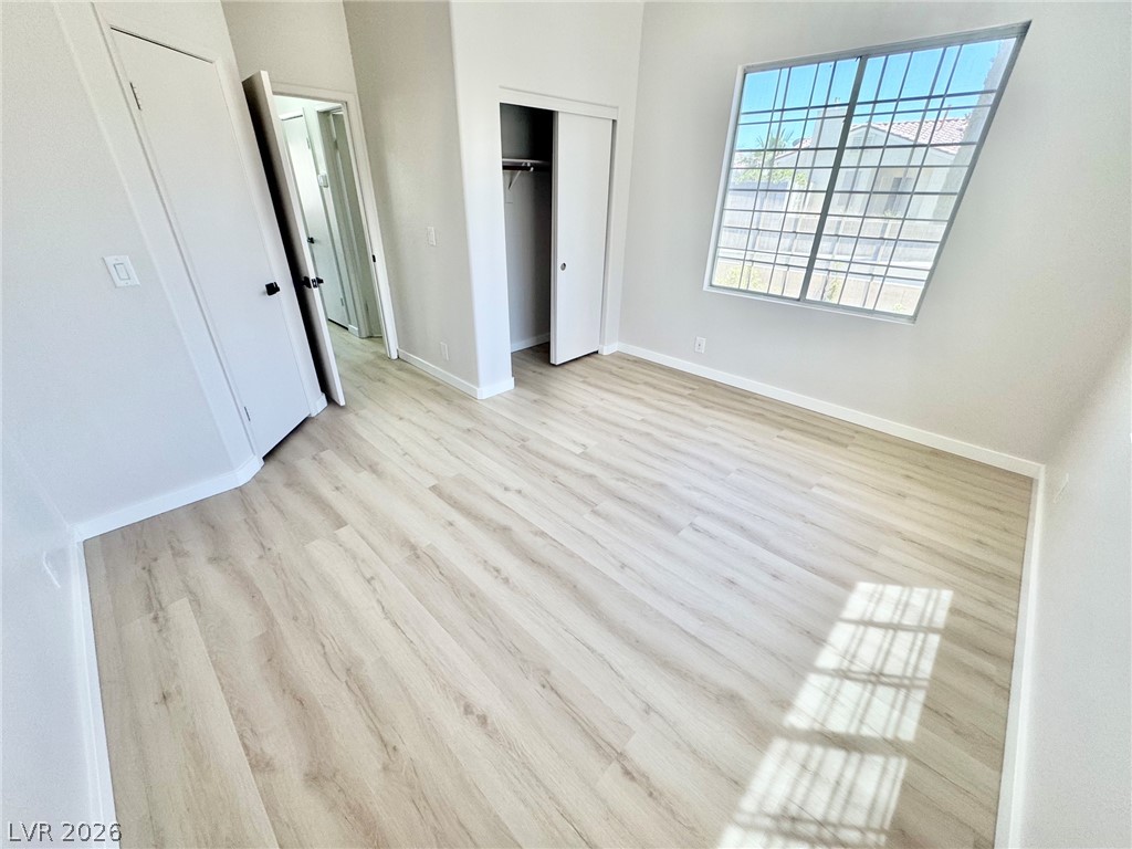 7340 Ridge Star Court Las Vegas, NV 89131 - Photo 10 of 22 A well-lit bedroom with pristine flooring and generous window views awaits new occupants.