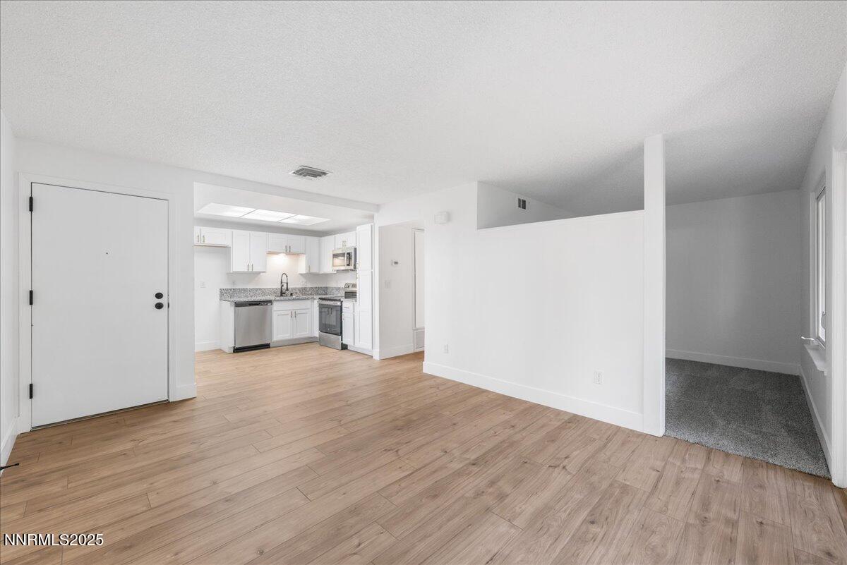 2136 Roundhouse Road Sparks, NV 89431 - Photo 17 of 26 a view of a kitchen with a sink and a refrigerator
