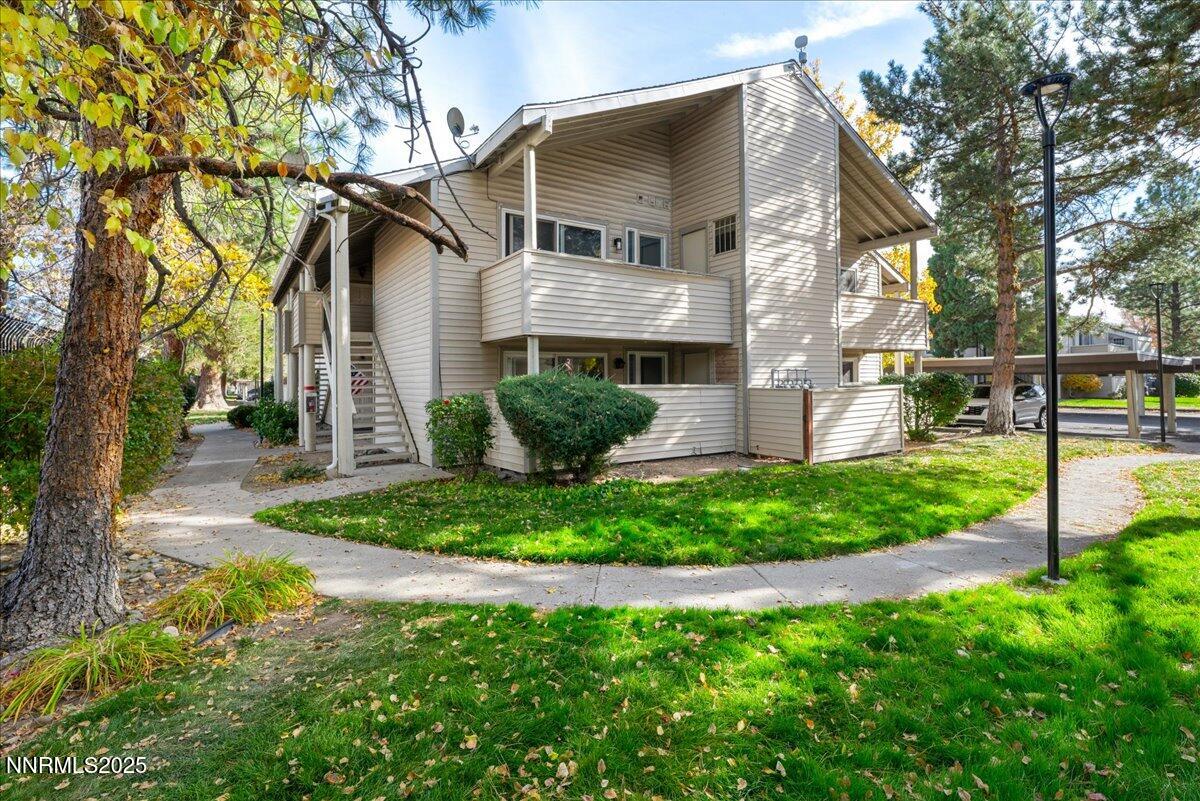 2136 Roundhouse Road Sparks, NV 89431 - Photo 23 of 26 a view of a white house next to a yard with big trees
