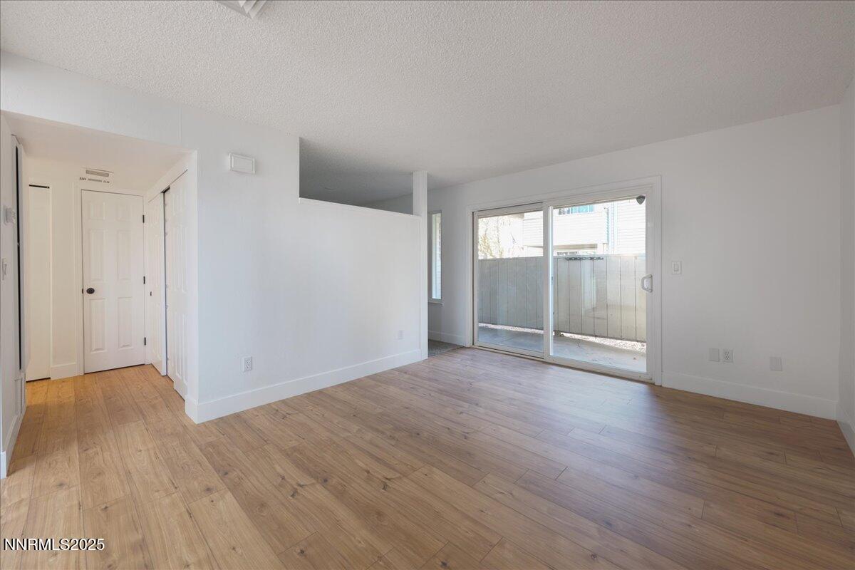 2136 Roundhouse Road Sparks, NV 89431 - Photo 3 of 26 a view of an empty room with wooden floor and a window