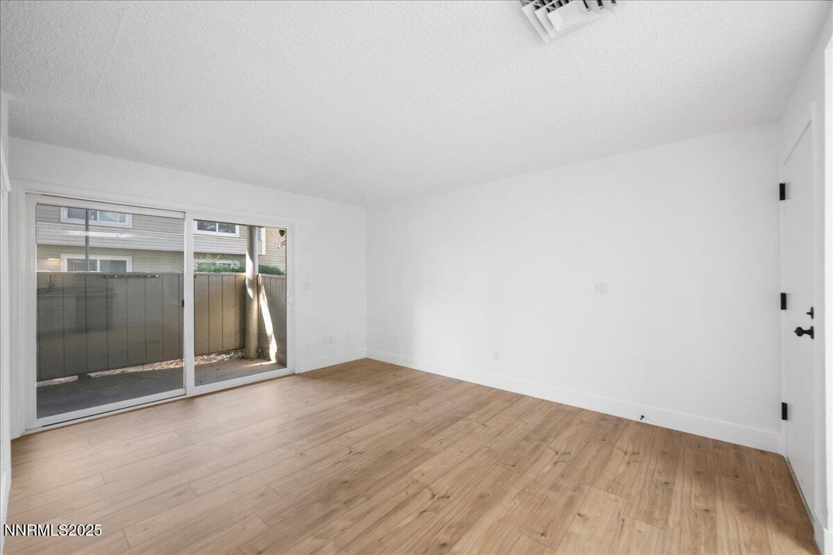 2136 Roundhouse Road Sparks, NV 89431 - Photo 4 of 26 a view of an empty room with wooden floor and a window